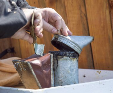 Eski Smoker kovan üzerinde duruyor. Arı sigara içen bal arılar sakin için Arıcılık kullanılan bir cihazdır. Çeşitli yakıtların için için yanan duman oluşturmak için tasarlanmıştır.
