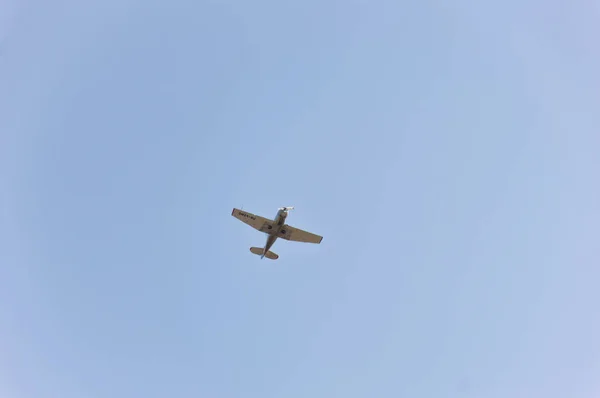 Propeller aircraft flying high in the sky.