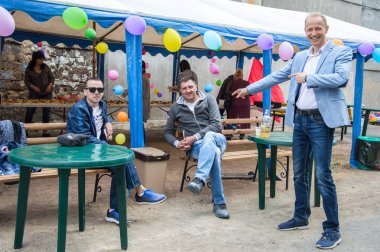 Çocuklar ve ebeveynler için açık etkinlik. Yetişkinler ve çocuklar dinlenir, tatlı yer, müzik dinler ve oyun oynarlar. Gülümseyen insanların portreleri.  