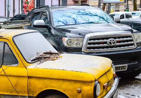 Yellow old machine and a large Toyota parked nearby. — Stock Photo, Image