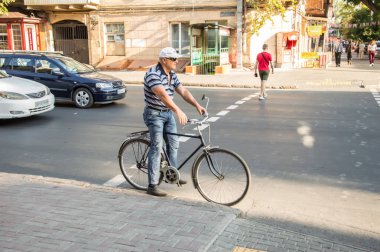 İnsanlar bisikletle çalışacak. Sokak, yol, arabalar.