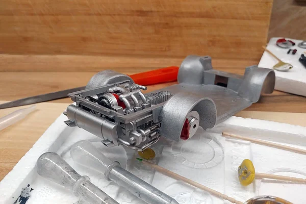 Modeling.  Build a scale model of the car. The engine with exhaust, gearbox and suspension are painted with an airbrush and mounted on a model body for assembly.