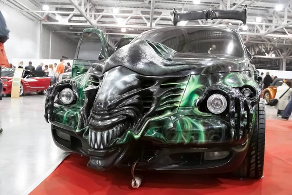 Moscow, Russia - May 25, 2019: Tuned and stylized as "Alien" Chrysler PT Cruiser at green and black color in the showroom. Stock Image