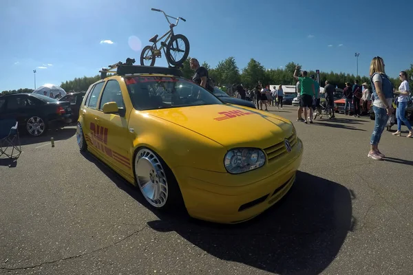Moscow, Russia - June 01, 2019: Yellow tuned Volkswagen Golf 4 in the colors of the company DHL in the parking lot. Modified by air suspension and custom wheels,