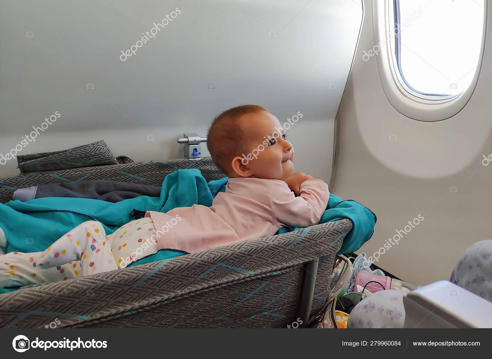 Happy Infant Baby Lyes In Special Bassinet In Airplane At His Stomach First Flight Of The Baby She Is Impressed But Teething Stock Photo By C Dven Happy Infant Baby Lyes In Special Bassinet In Airplane At His Stomach First Flight Of The Baby She Is Impressed But Teething Stock Photo By C Dven