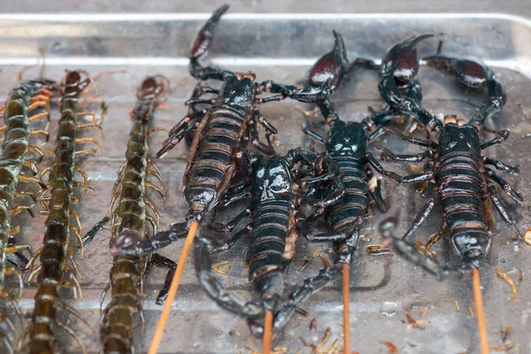 Scorpios on sticks in a chinese market — Stock Photo, Image