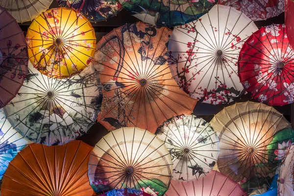Multi colored chinese umbrellas illuminated at night