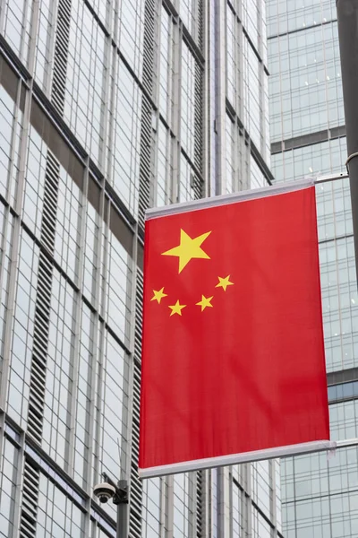 chinese flag against skyscraper facade