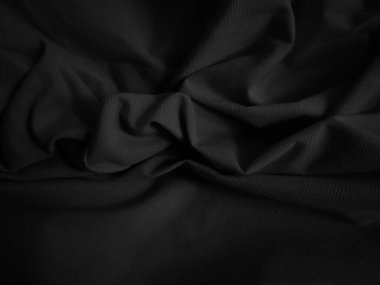 Siyah buruşuk kumaş dokusu. Koyu renk arka plan