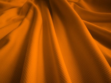 Turuncu buruşuk kumaş arkaplan. Dalgalı kumaş dokusu