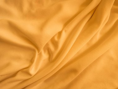 Turuncu buruşuk kumaş arkaplan. Dalgalı kumaş dokusu