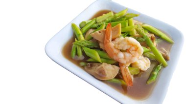 Beyaz arka planda karides kızarmış kuşkonmaya, seçici odak