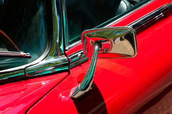 rear mirror, car mirror closeup on red oldtimer car