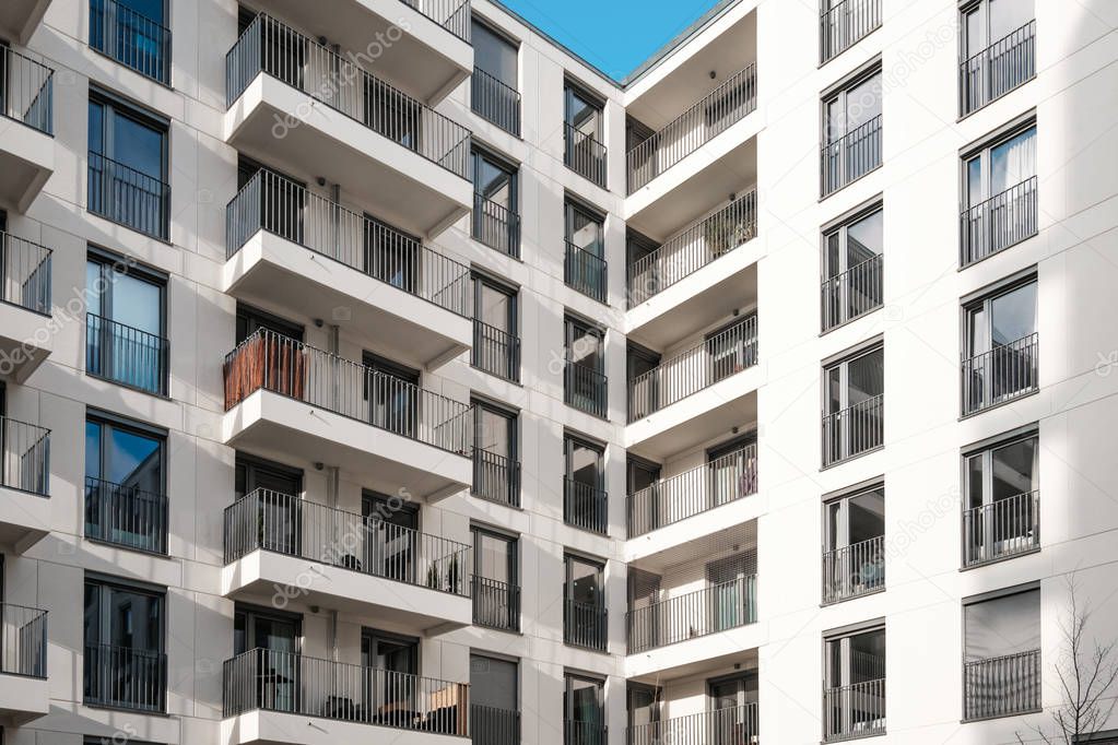 balcony facade on corner of modern apartment building complex -