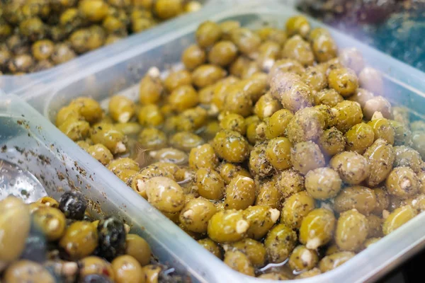 green olives at market  - marinated olives stuffed with almonds