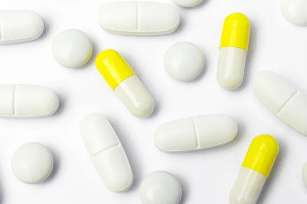 Group of pills, yellow capsules on white background — ストック写真