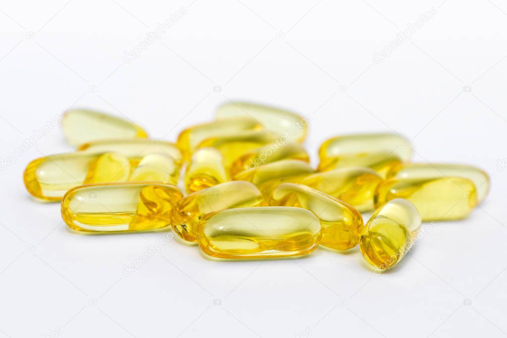 vitamin pills or gel capsules on white background 