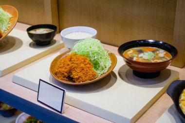 Asya restoranının vitrininde sahte plastik yemek menüsü -