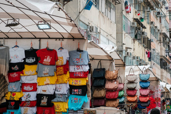 HongKong, China - November, 2019: T-shirts, clothing and bags on street market (Ladie`s Market) in Hong Kong  , Tung Choi Street