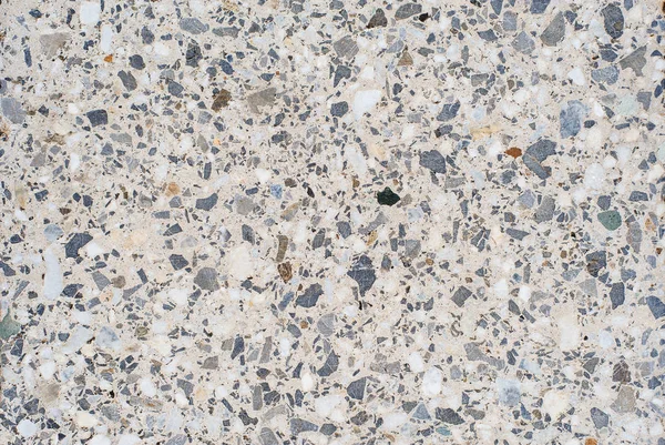 The texture or background of a light granite tile interspersed with stone for design. Granite slab, marble texture