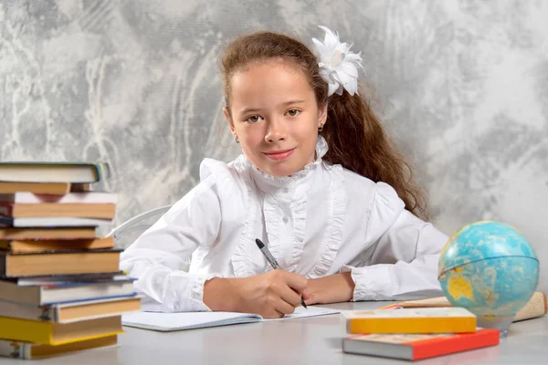 Skolflickas Skoluniform Sitter Vid Skrivbordet Och Och Skriver Något Anteckningsboken — Stockfoto