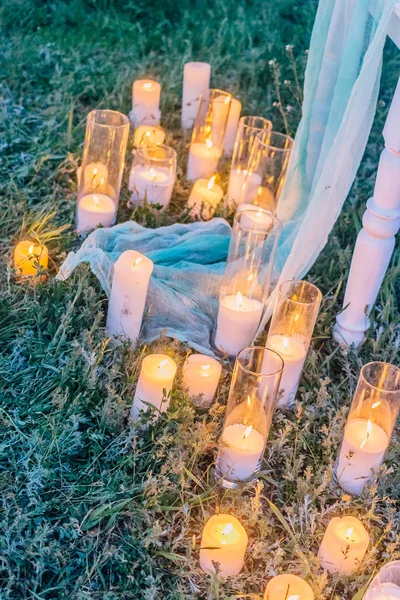 Many burning candles on ground. Beautiful place for outside wedding ceremony in wood. — Stock Photo, Image