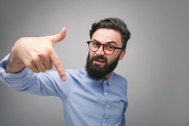 Bully man in glasses gesturing at camera clipart