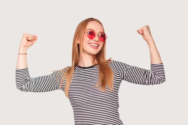 Cheerful woman flexing arms — Stock Photo, Image