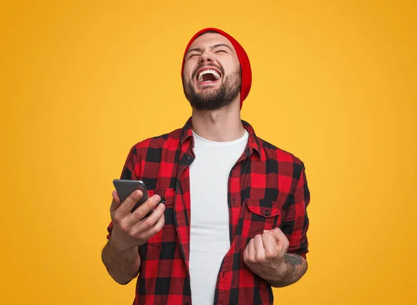 Happy male with smartphone celebrating success — Stock Photo, Image