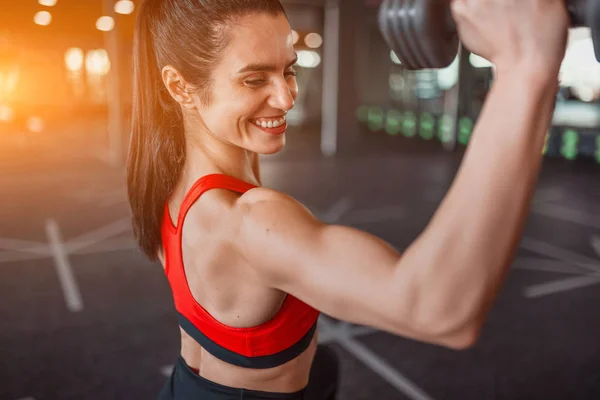 Cheerful woman training with dumbbell — Stock Photo, Image