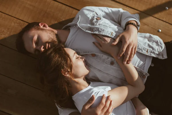 Cute couple sleeping on wooden surface — Stock Photo, Image