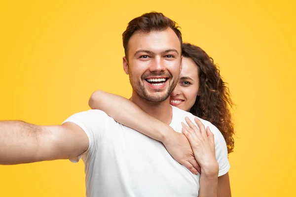 Casal abraçando e tirando selfie — Fotografia de Stock