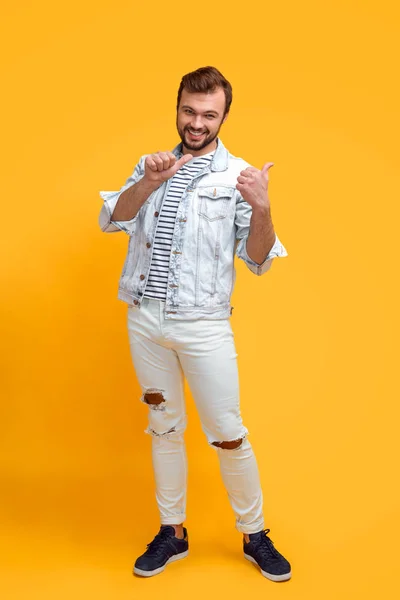 Cheerful hipster pointing away — Stock Photo, Image