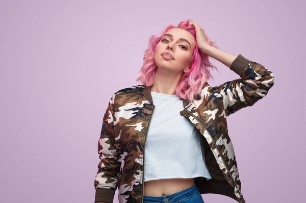 Young woman touching hair and smoking