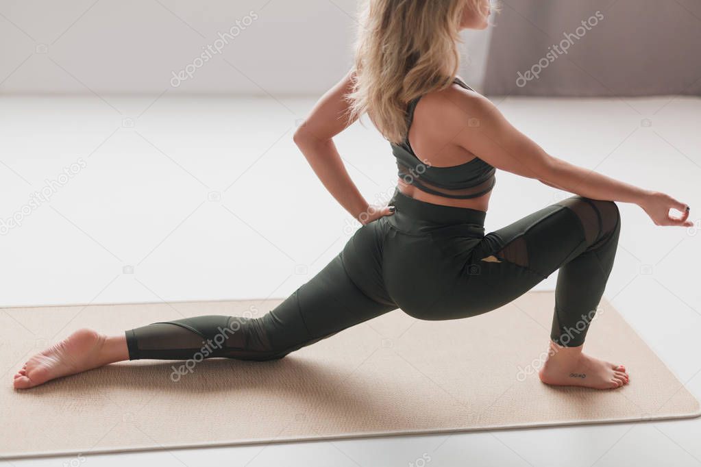 Slim woman training on yoga mat