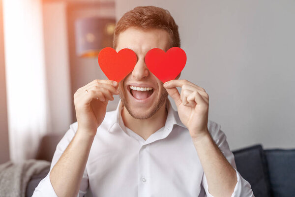 Excited man with hearts near eyes