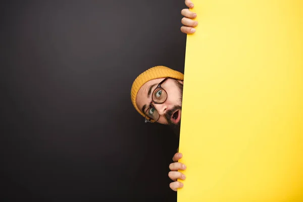 Zabawny człowiek wychylająca się zza transparent żółty — Zdjęcie stockowe