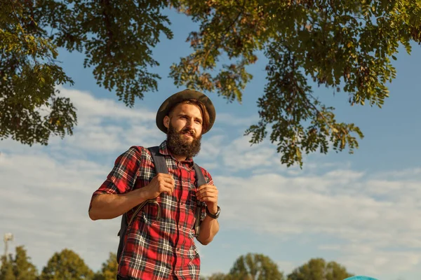 Bearded hipster traveling in nature