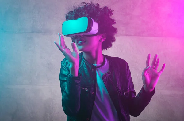 Curly girl in Virtual Reality goggles — Stock Photo, Image