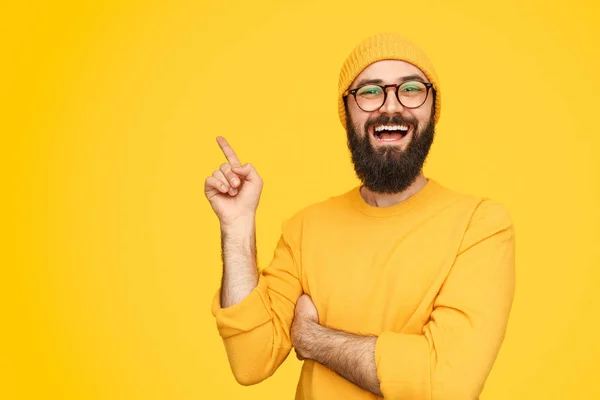 Excited trendy guy pointing aside — Stock Photo, Image
