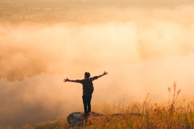 Doğada uzanmış kolları olan anonim erkek