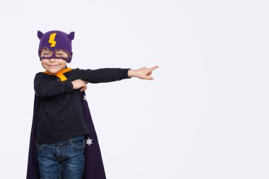 Bir kenara işaret eden küçük süper kahraman