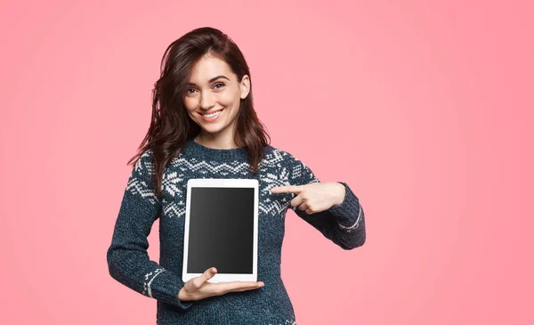 Cute female pointing at tablet