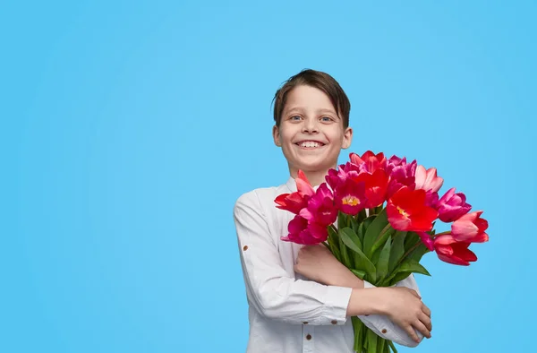 Anak yang bersemangat dengan sekelompok tulip untuk saat ini — Stok Foto