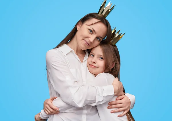 Madre e hija cariñosas en coronas abrazando — Foto de Stock