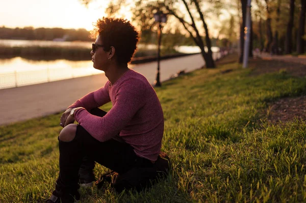 Stylish pensive man in green park looking away — Stok Foto