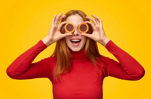 Happy girl covering eyes with cookies — Stock Photo, Image
