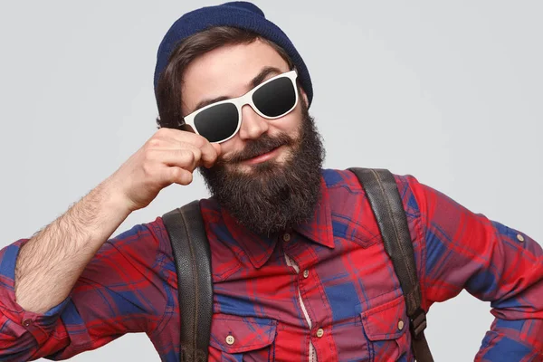 Modern cheerful hipster in sunglasses curling mustache — Stock Photo, Image