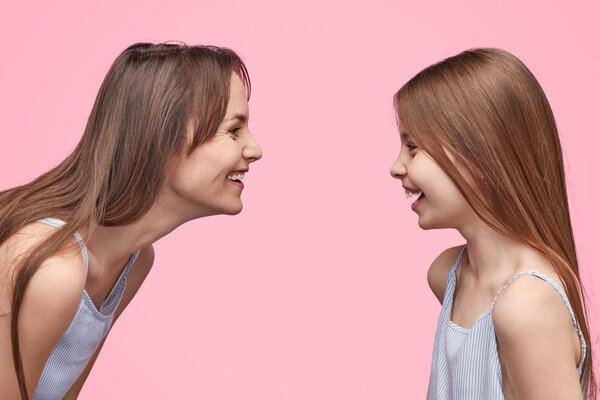 Laughing woman and girl looking at each other