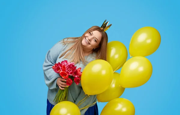 Glada plus size kvinna med blommor och ballonger — Stockfoto